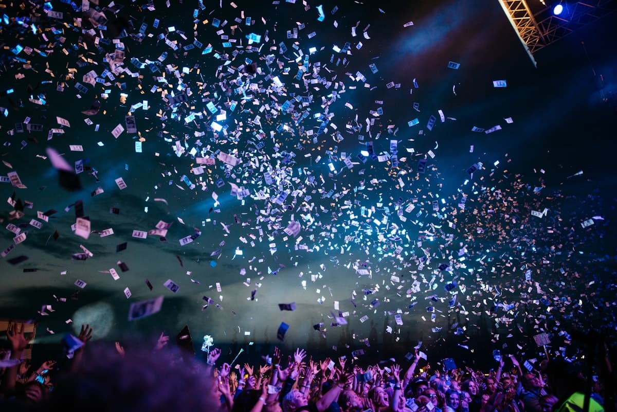 Festival crowd in front of a bright stage